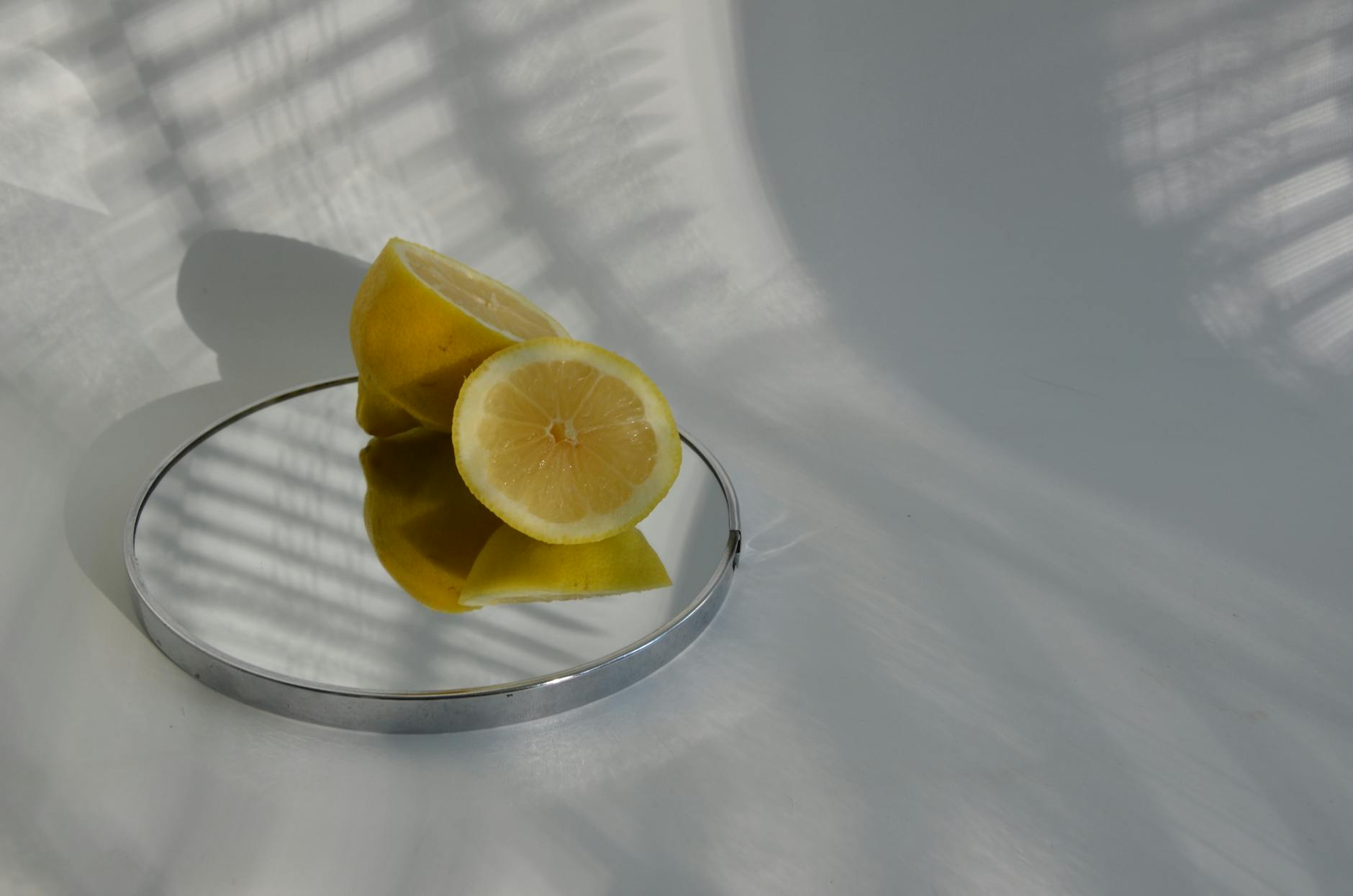 Sliced lemons on a reflective surface showing how estrogen changes can create similar shifts in sensation