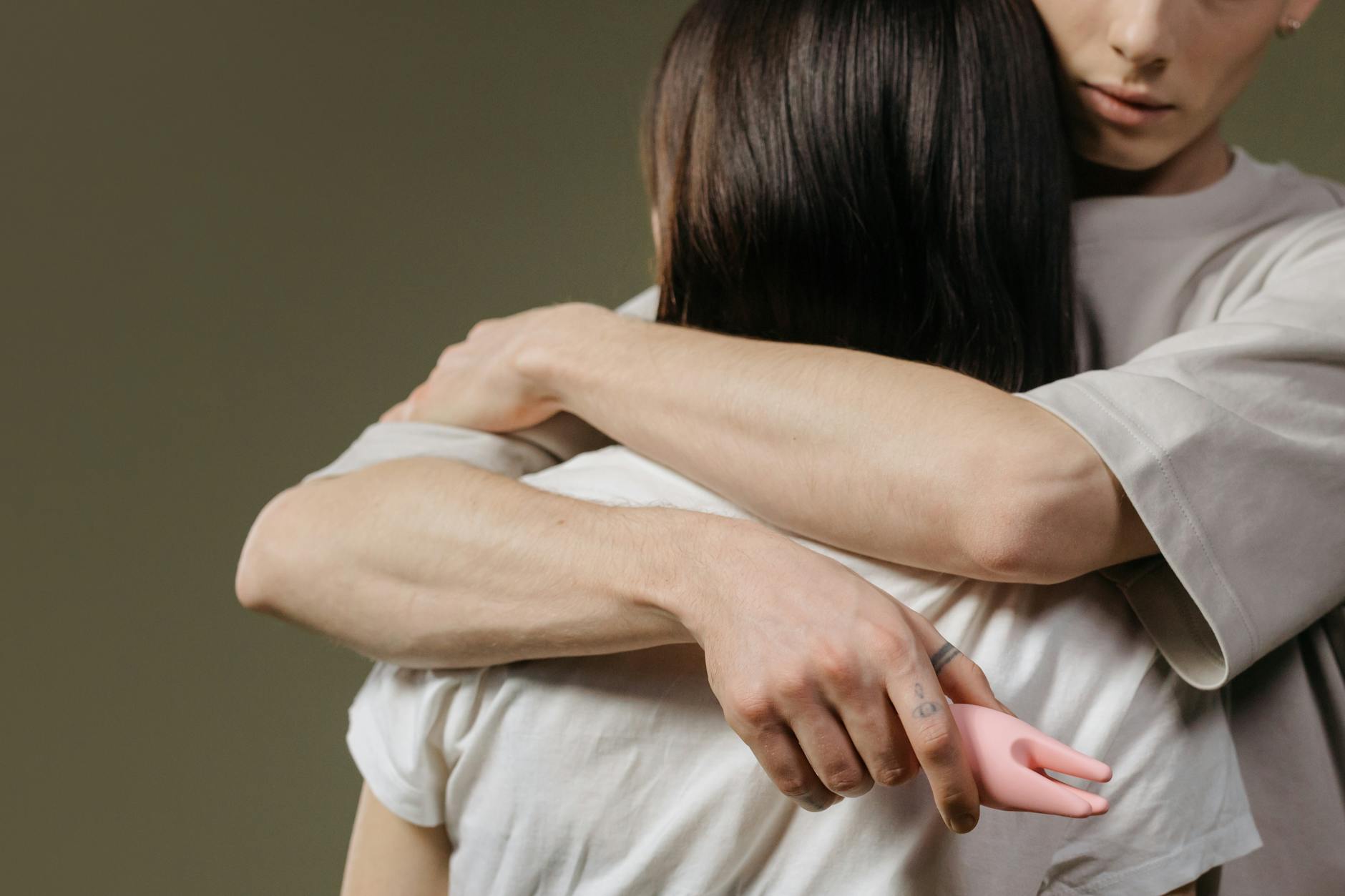 Close-up of a couple embracing in bed, showing physical intimacy and connection across different body types.